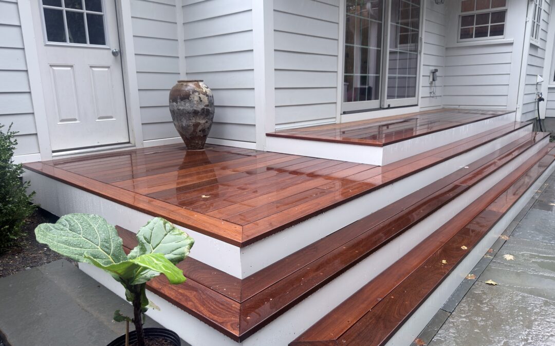Finished Ipe deck with broad stairs beside a white house